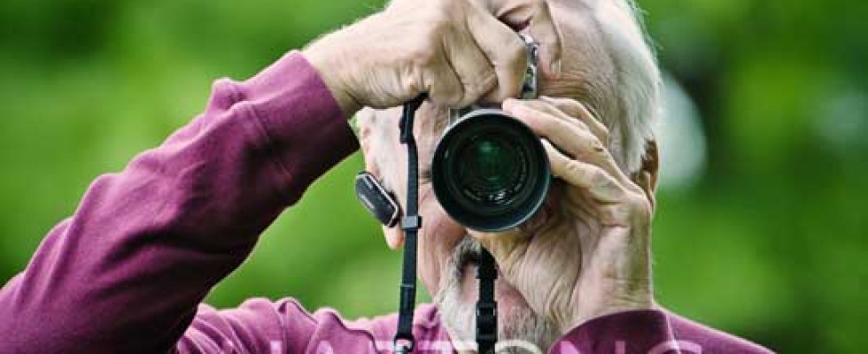 man with camera taking pictures during photography class in Cincinnati